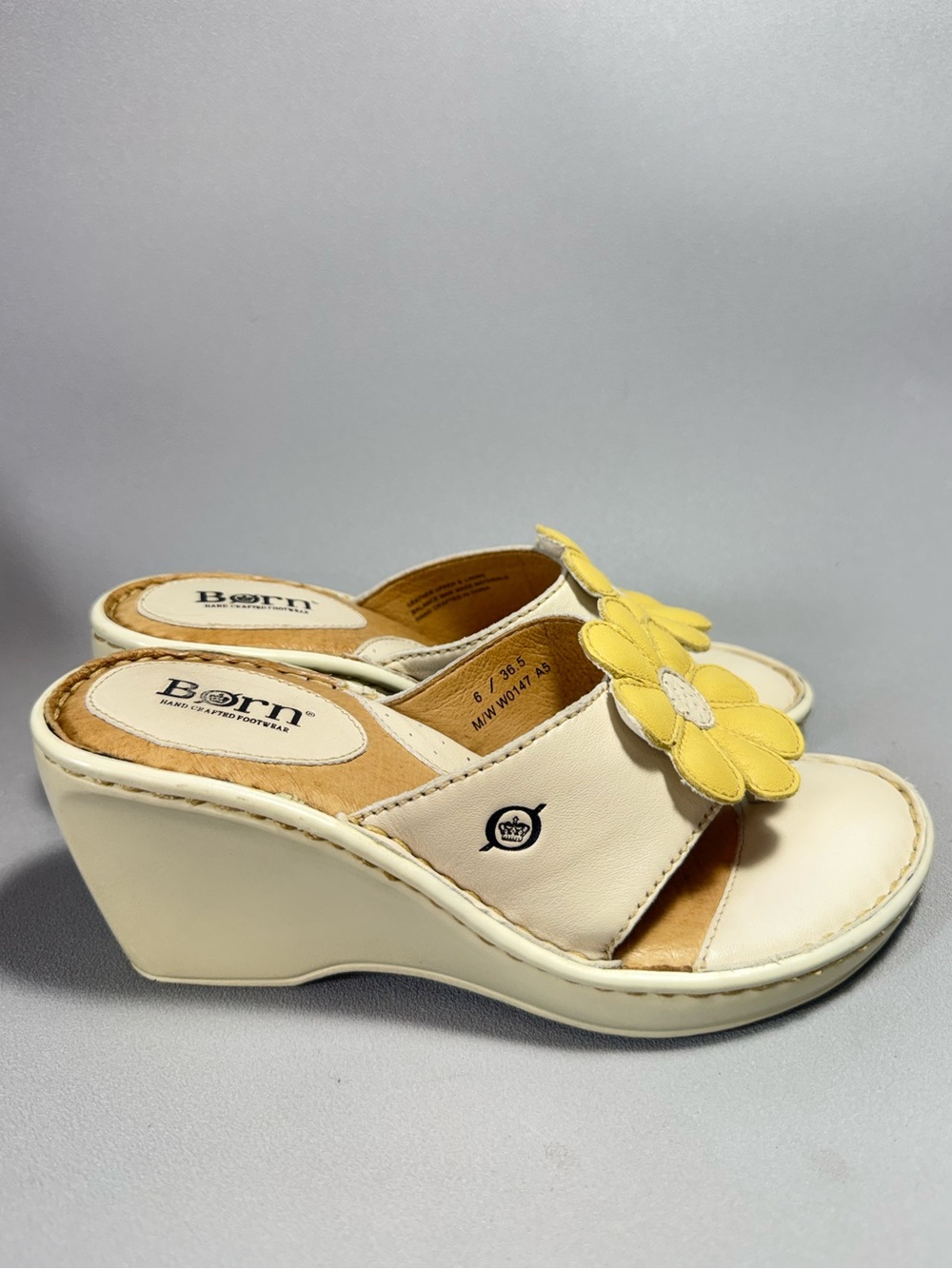 Born Off-White Leather Slide Wedge Sandals with Yellow Floral Accent